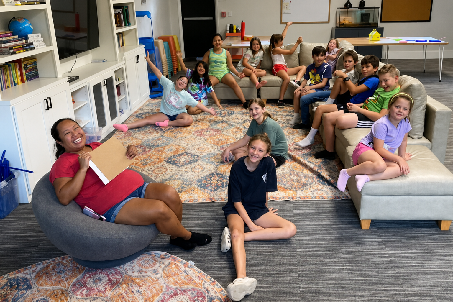 Smiling children and teachers gathered in our cozy school age program space